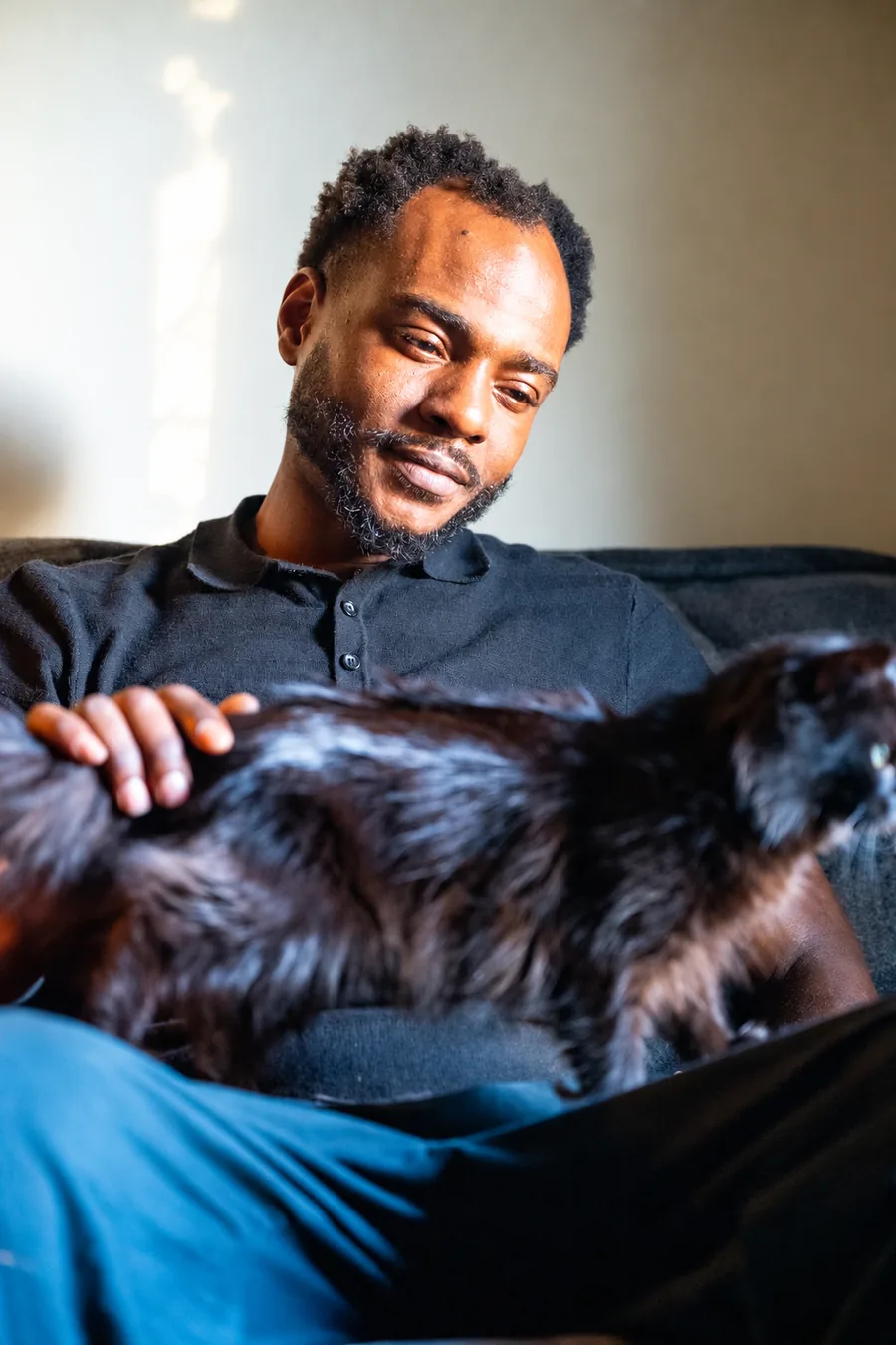 Nafis Garrett, founder of Raleigh Reserve, with Raleigh, the cat who inspired the brand